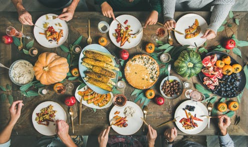 Five friends sitting at the decorated Friendsgiving dinner table