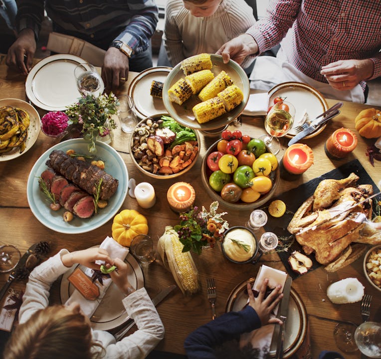 Top-down photo of a table covered in Thanksgiving dishes.
