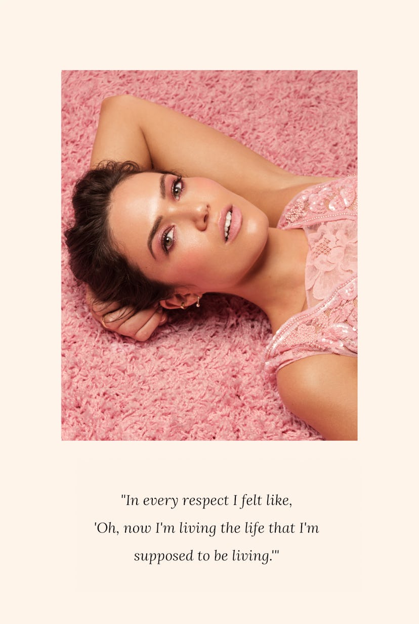 A brunette lady lying down on the carpet