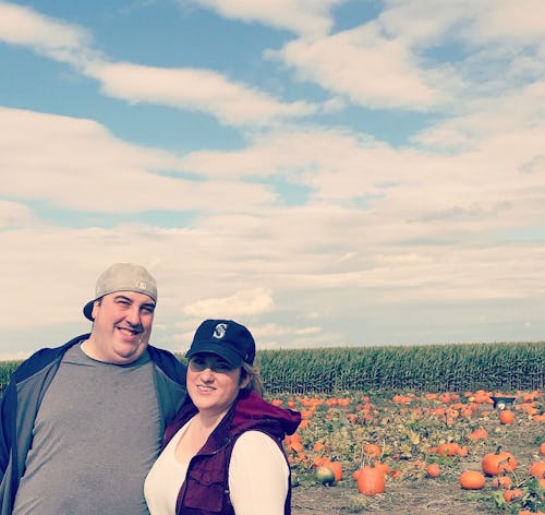 Jessie Glockling and her husband posing in a pumpkin field