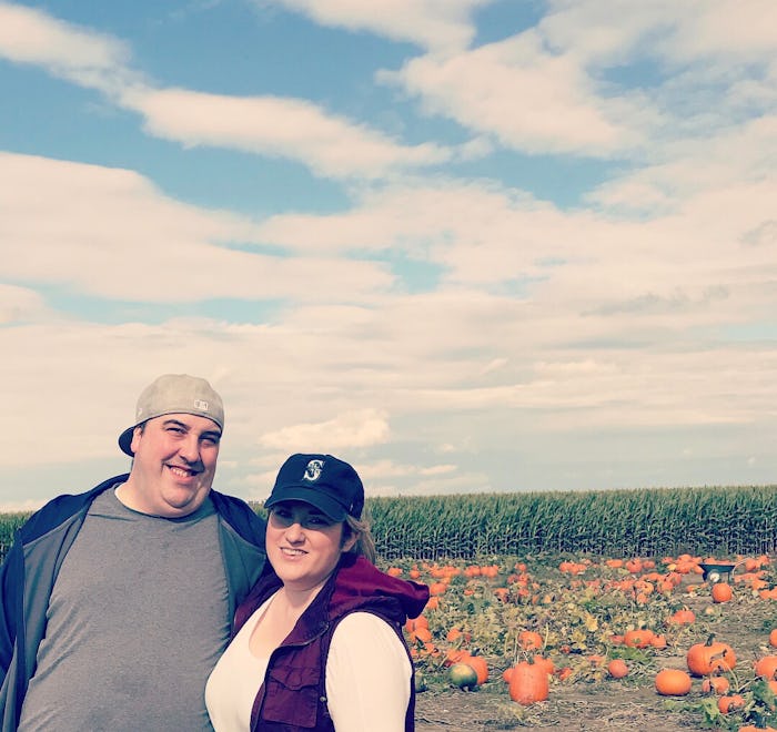 Jessie Glockling and her husband posing in a pumpkin field