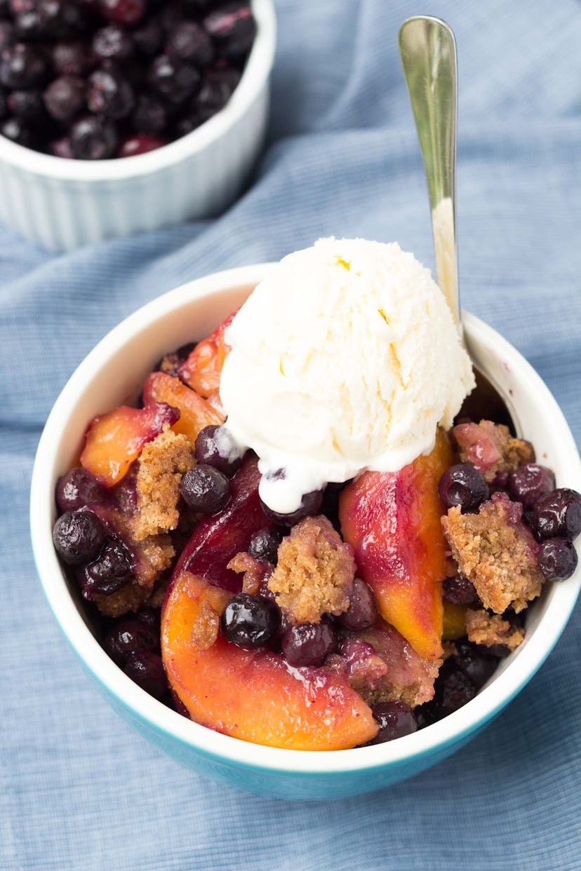 Thanksgiving Desserts: Blueberries and peaches in a bowl with a crumble topped with ice cream