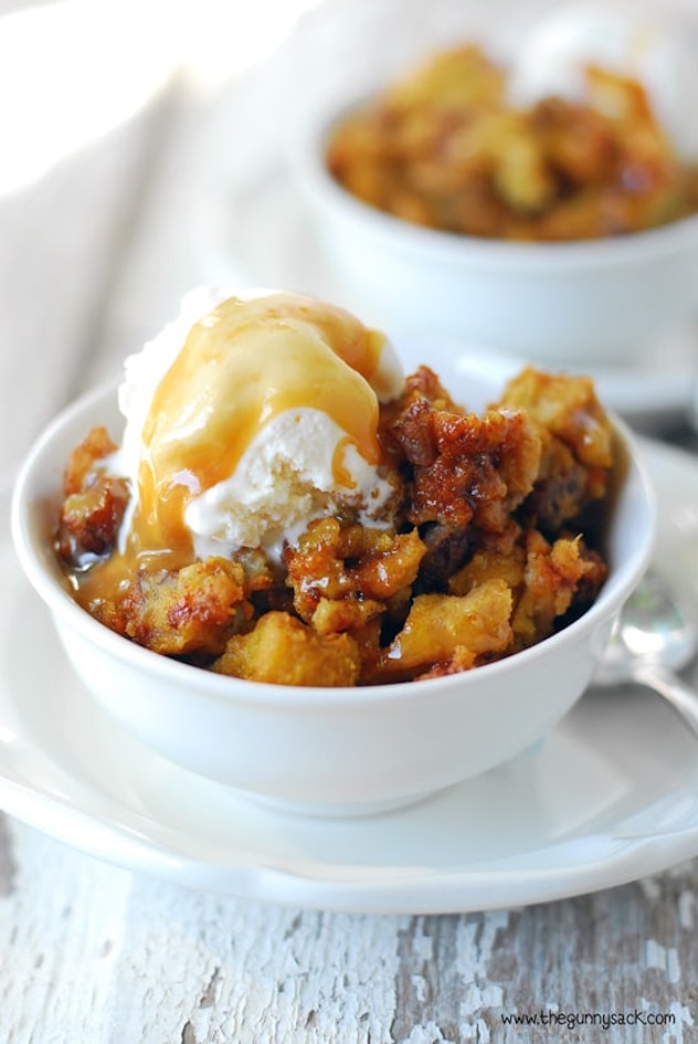 Thanksgiving Desserts: Two bowls of pumpkin pecan bread pudding topped with ice cream and caramel dr...