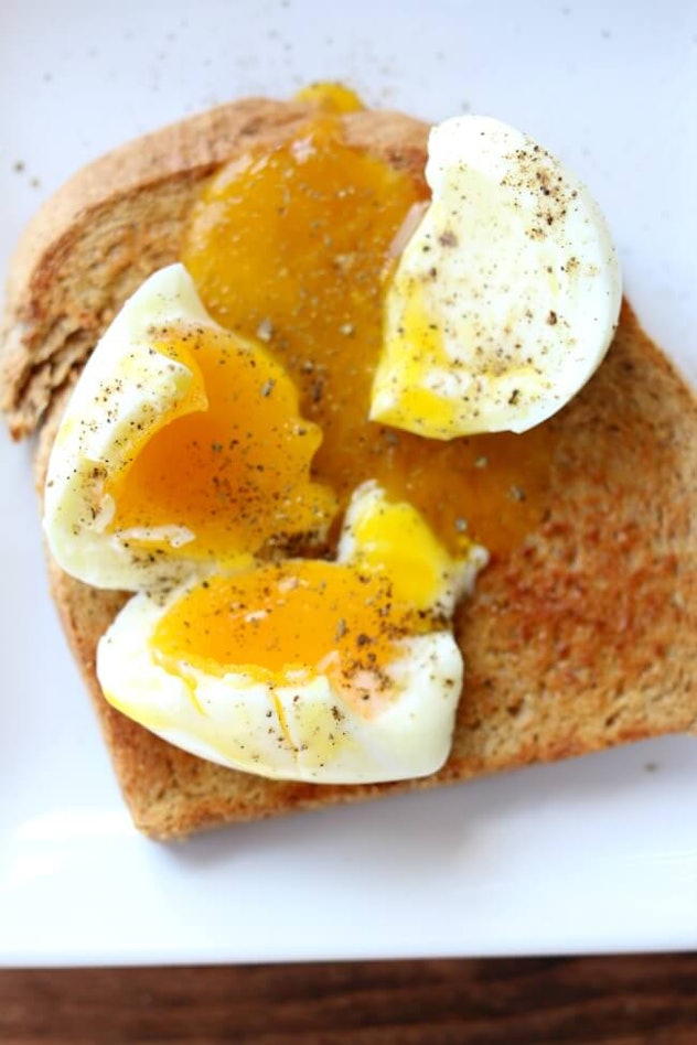 broken soft boiled egg on toast