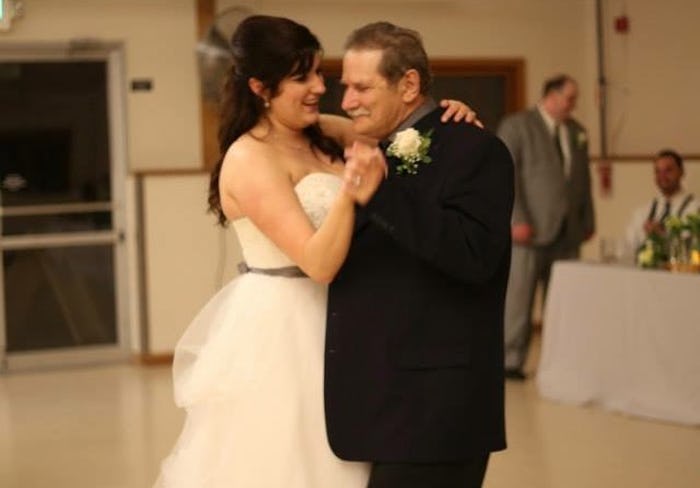 Jessie Glockling in a white dress dancing with her father
