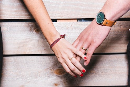 Two hands holding one another and letting go, showing how depression can disrupt a couple's sex life