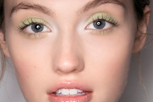 A close-up portrait of a woman who is using the unexpected eyeshadow trend