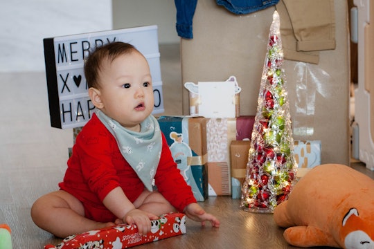 baby sitting with christmas decorations