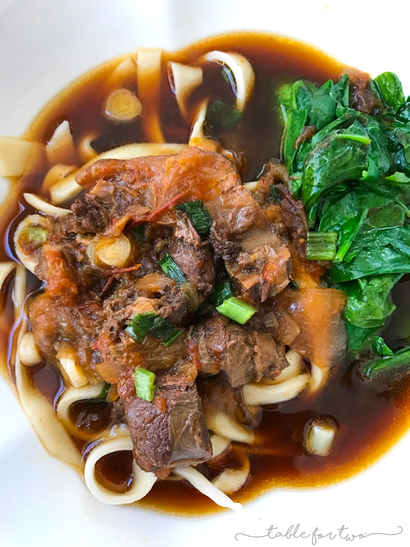 beef and noodles in a stew with spinach