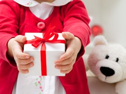 little girl holding gift
