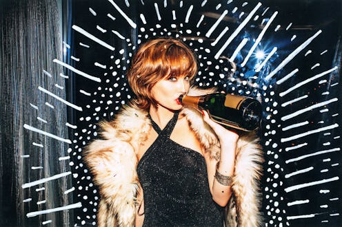 A woman in a black evening dress and a fur coat drinking champagne straight from the bottle