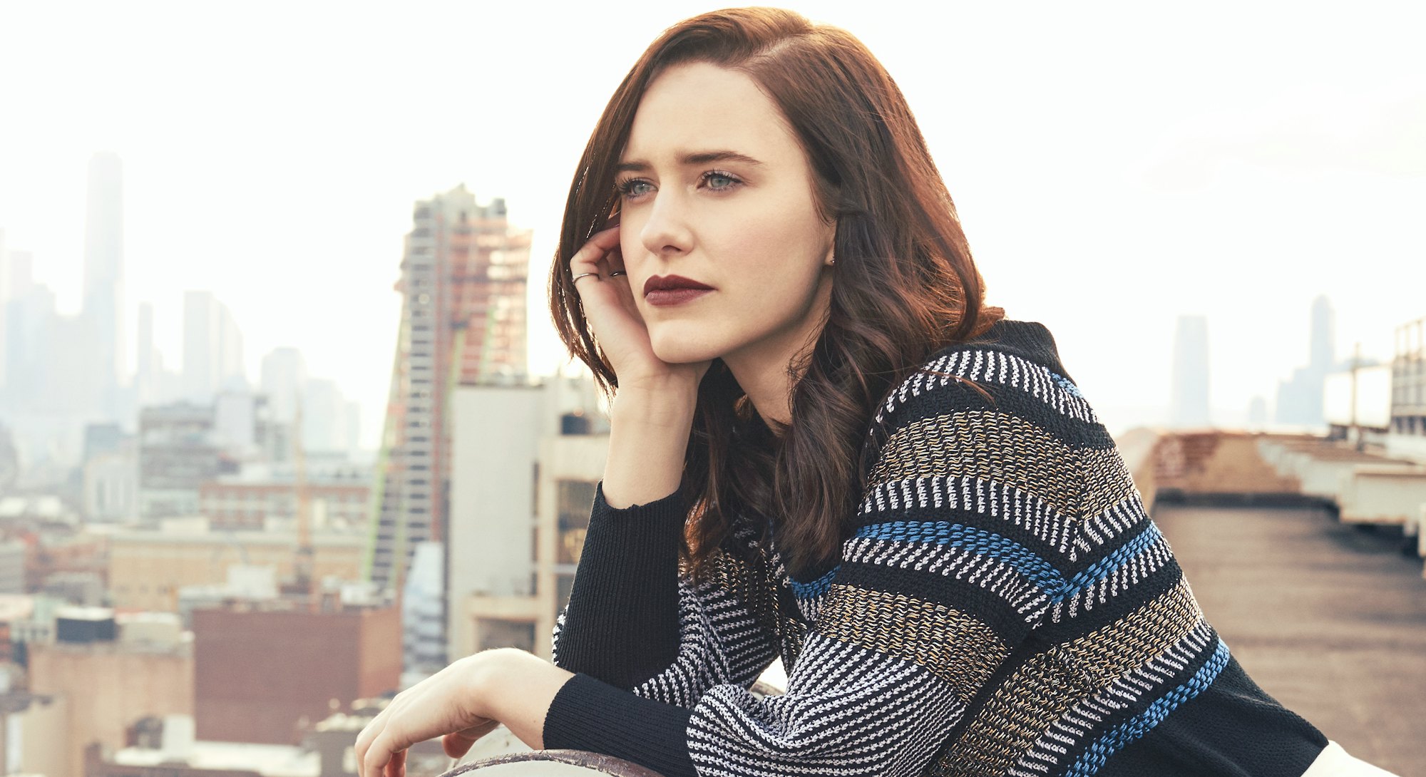 Rachel Brosnahan looking at the city from a rooftop
