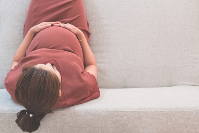 pregnant woman relaxing on the couch