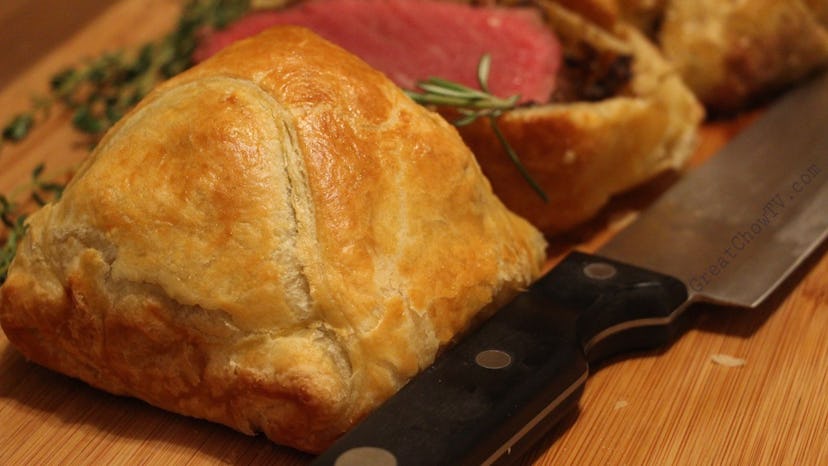 close up of beef wellington next to knife