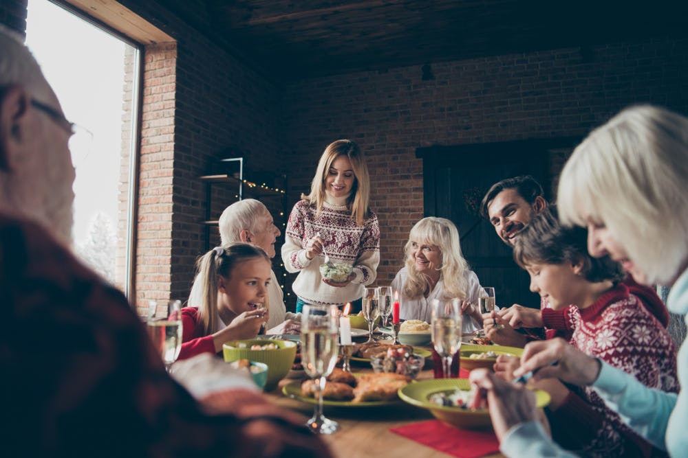 A big family with grandparents and grandkids having a meal for the holidays