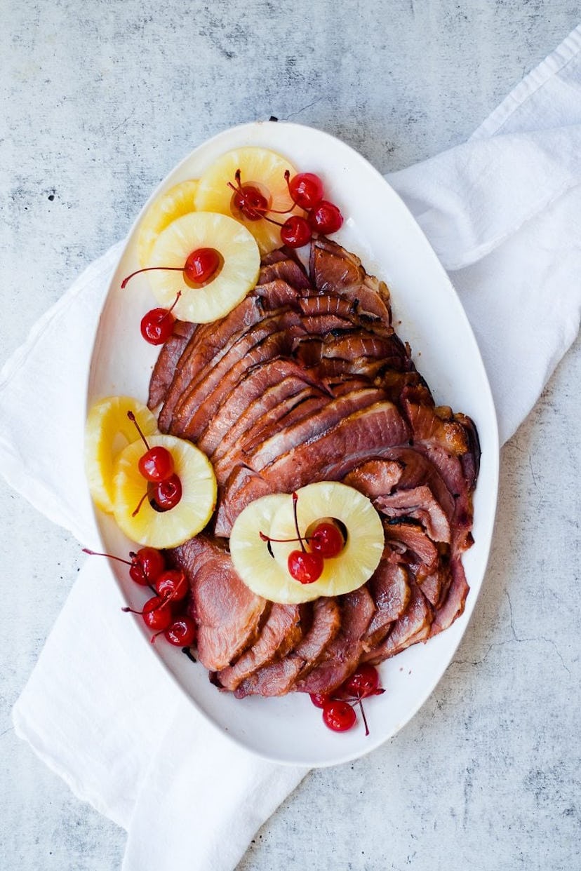 aerial view of sliced ham with rings of pineapple and cherries