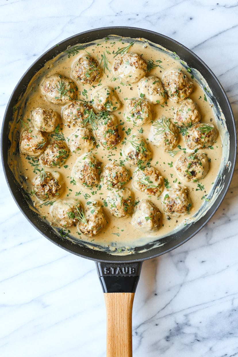 aerial view of pan with meatballs soaked in a light creamy sauce