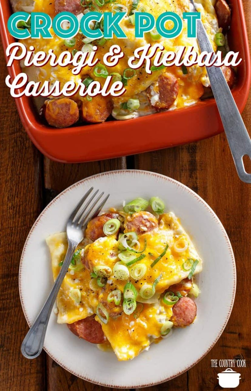White plate of pierogi kielbasa casserole with a fork next to a red dish of the entire casserole