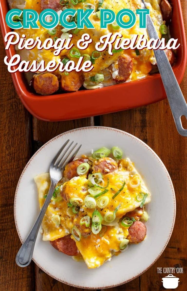 White plate of pierogi kielbasa casserole with a fork next to a red dish of the entire casserole