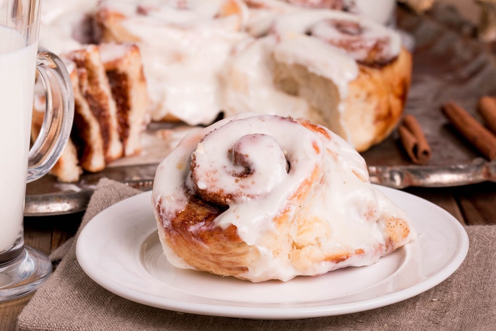 Cinnamon roll served on a plate on Christmas morning breakfast