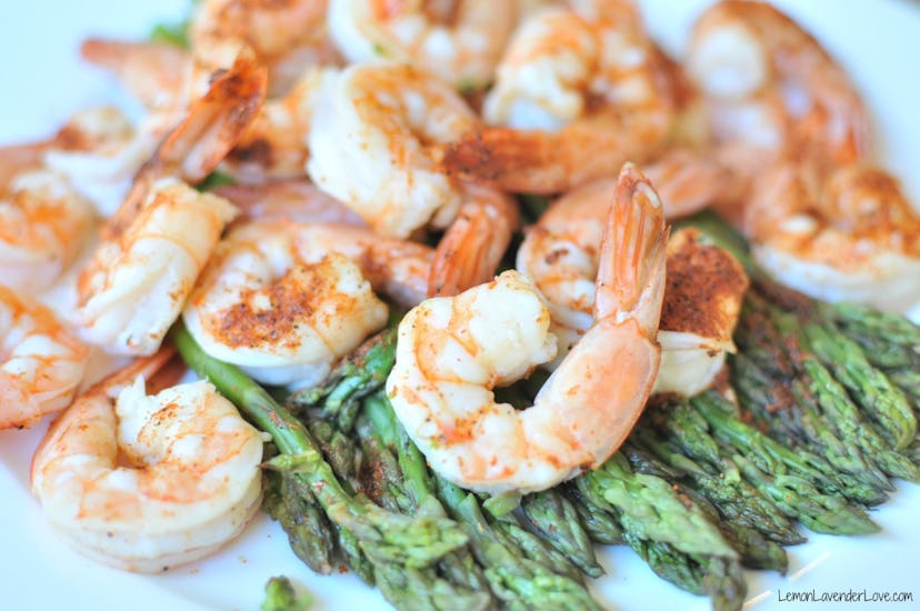 cooked shrimp on a bed of asparagus 