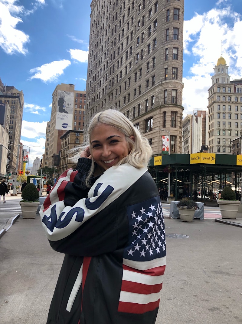 Iman Hariri-Kia, diagnosed with a digestive illness, wearing a jacket with the flag of the USA while...