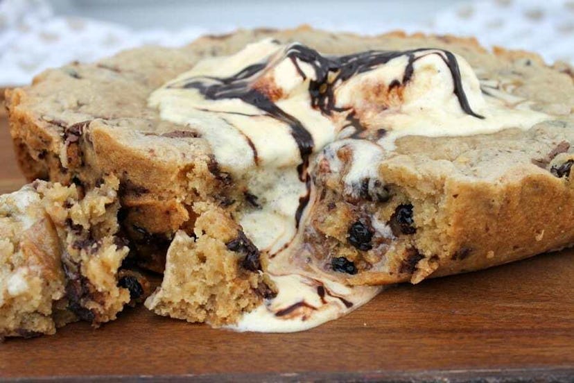 Large chocolate chip cookie with vanilla ice cream melting off