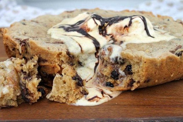 large chocolate chip cookie with vanilla ice cream melting off