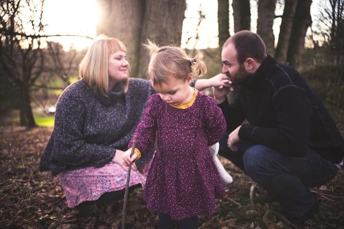 A man and woman, who are ttc a second child, spending time with their first child in nature