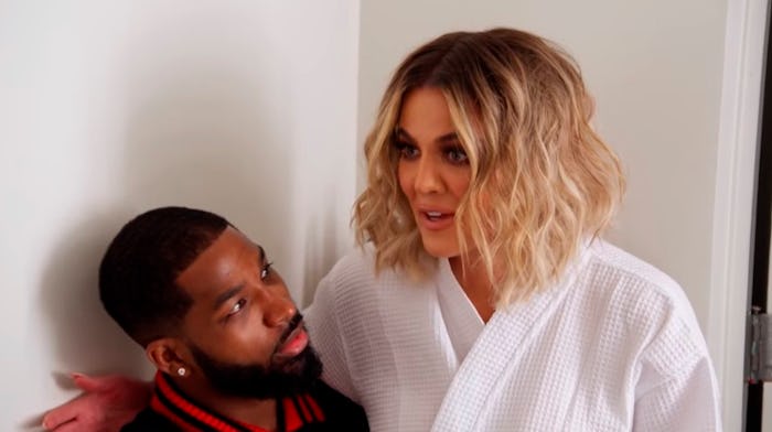 Khloé Kardashian sitting in the lap of Tristan Thompson