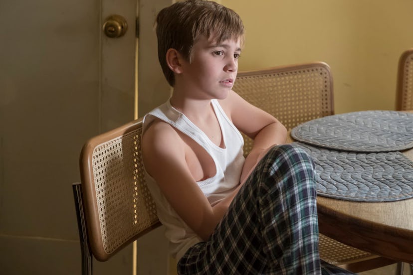 Parker Bates as Kevin sitting on the chair in his pajamas 