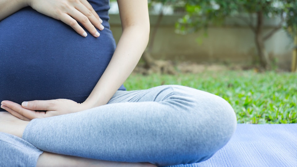 7 Yoga Poses To Induce Labor, Because You're Ready To "Om" This Baby Out