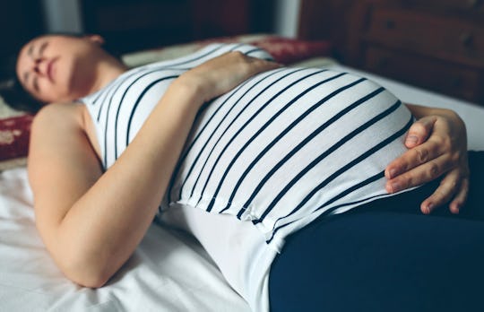 Sleeping on your back isn't always the most comfortable way to rest during pregnancy, experts say.