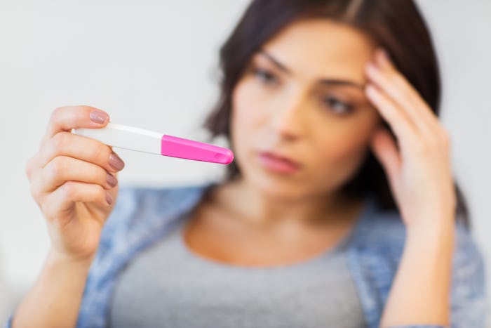 A woman trying to conceive looking at the pregnancy test