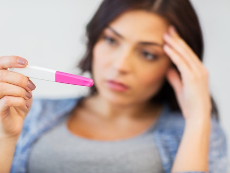 A woman trying to conceive looking at the pregnancy test