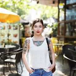 Tattooed woman in a bar garden that possibly has PCOS