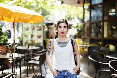 Tattooed woman in a bar garden that possibly has PCOS