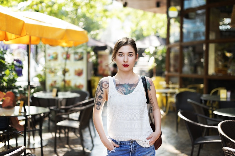 Tattooed woman in a bar garden that possibly has PCOS