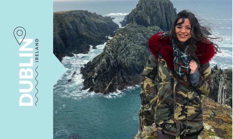 BDG editor Kaitlyn Cawley on a cliff in Dublin, while behind her is a view of the Atlantic Ocean.