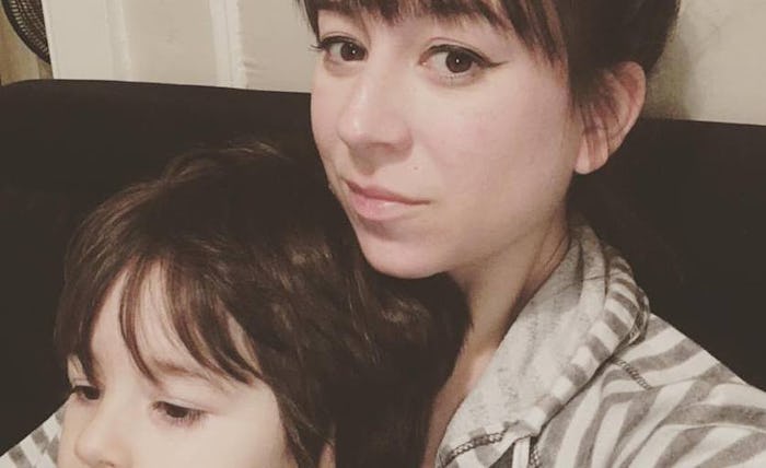 A picture of the author sitting on a couch with her young son.