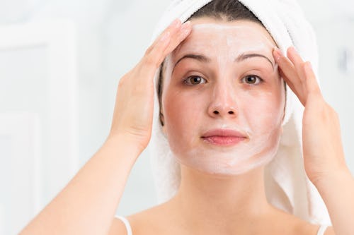 A woman putting on an overnight face mask
