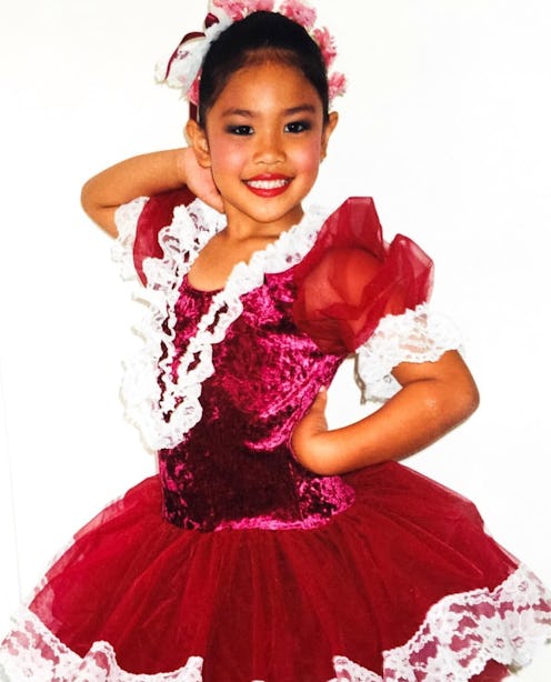 A little girl posing in a red dress