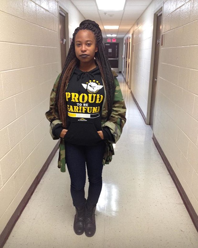 Keyanna Gotay wearing a camo jacket, while standing in a hallway