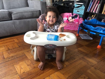 A toddler sitting in a feeding chair