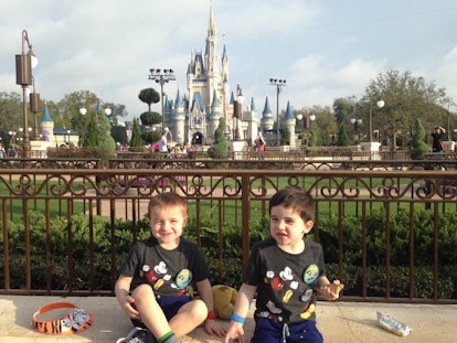 Two boys in front of Cindarella's castle at the Magic Kingdom