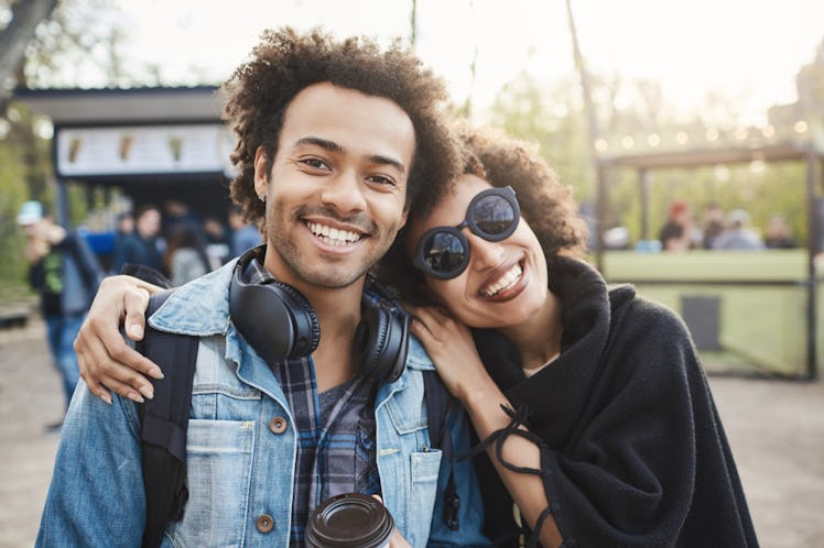 Young woman hugging and posing for a pic with her brother before posting on Instagram with a birthda...