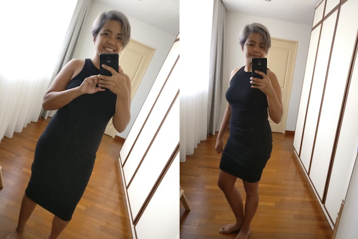 A new mom taking a mirror selfie in the hall while wearing a 10$ black dress