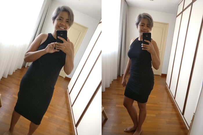 A new mom taking a mirror selfie in the hall while wearing a 10$ black dress