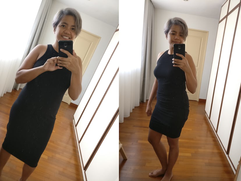 A new mom taking a mirror selfie in the hall while wearing a 10$ black dress