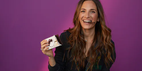 The Founder Of 'Baked By Melissa' Melissa Ben-Ishay, taking a bite of her dark chocolate